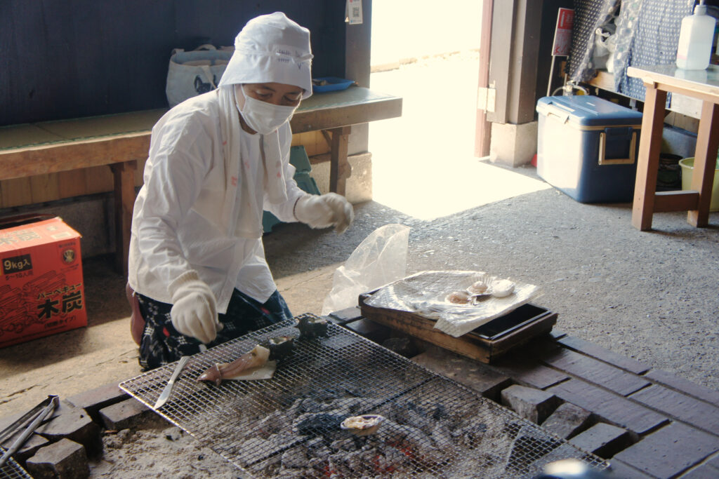An Ama prepares a charcoal grill for the Amagoya experience lunch.